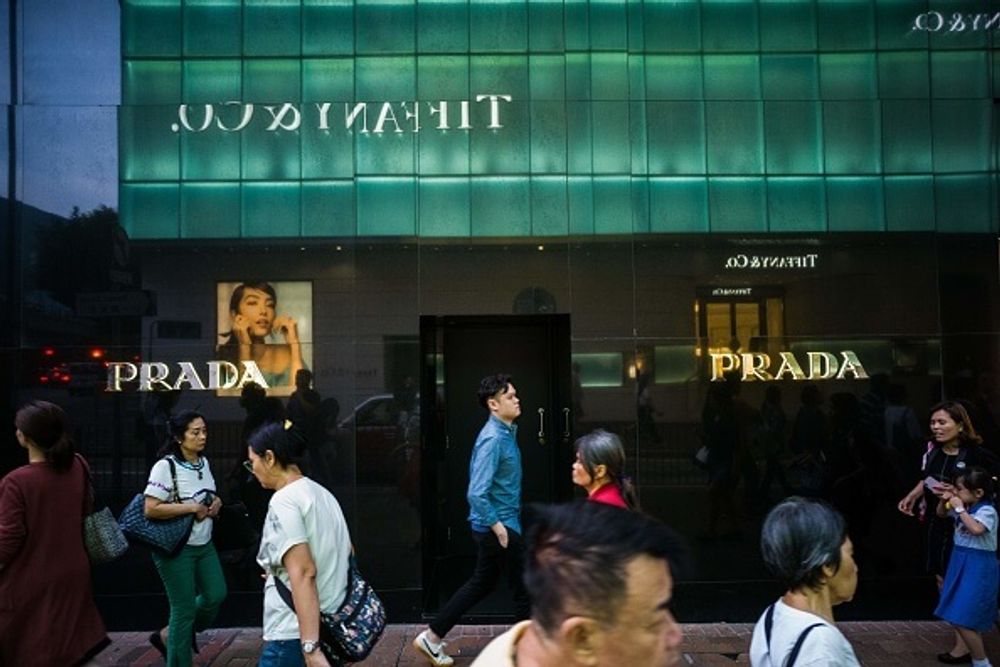 Shoppers walking in front of Prada and Tiffany in Hong Kong's Russell Street