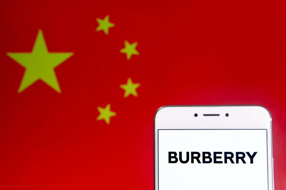 A phone open to the Burberry app in front of a China flag