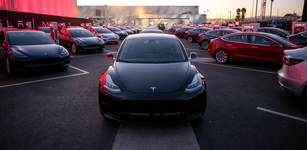 A photo of a Tesla vehicle parking lot