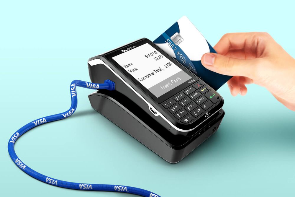 A debit card swipe taking money in a Visa tube