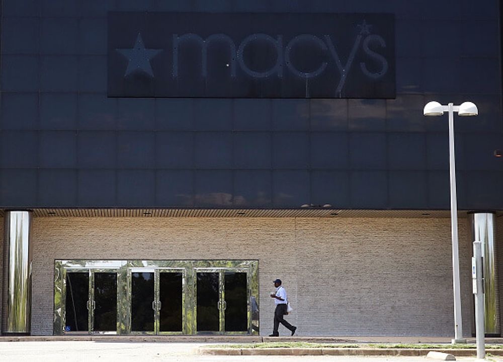 A man walks outside of a closed Macy's