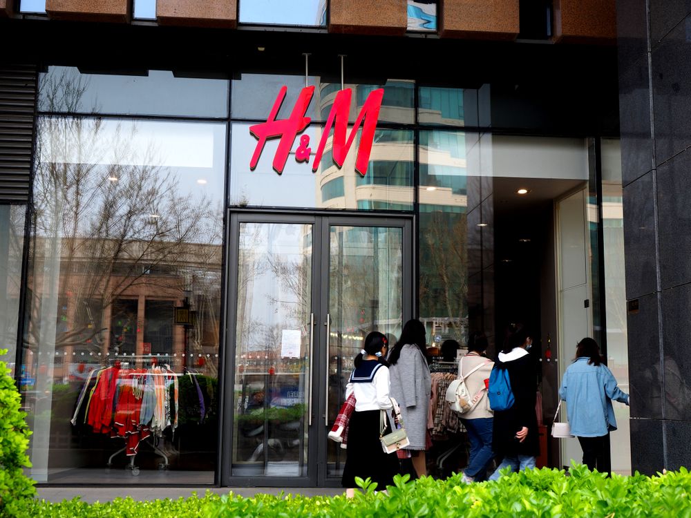 JINAN, CHINA - MARCH 26: People walk past a closed H&M store at a shoppi...
