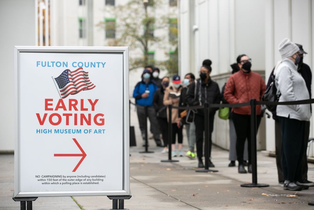 ATLANTA, GA - DECEMBER 14: Voters line up for the first day of early vot...