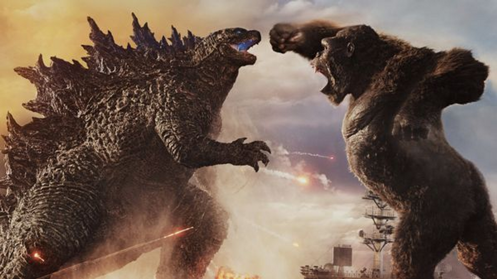 Godzilla monster fighting King Kong