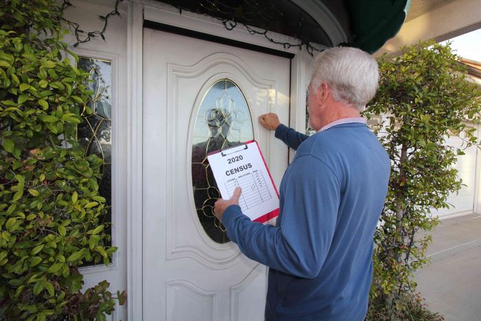 Man knocking on a door to take the 2020 census