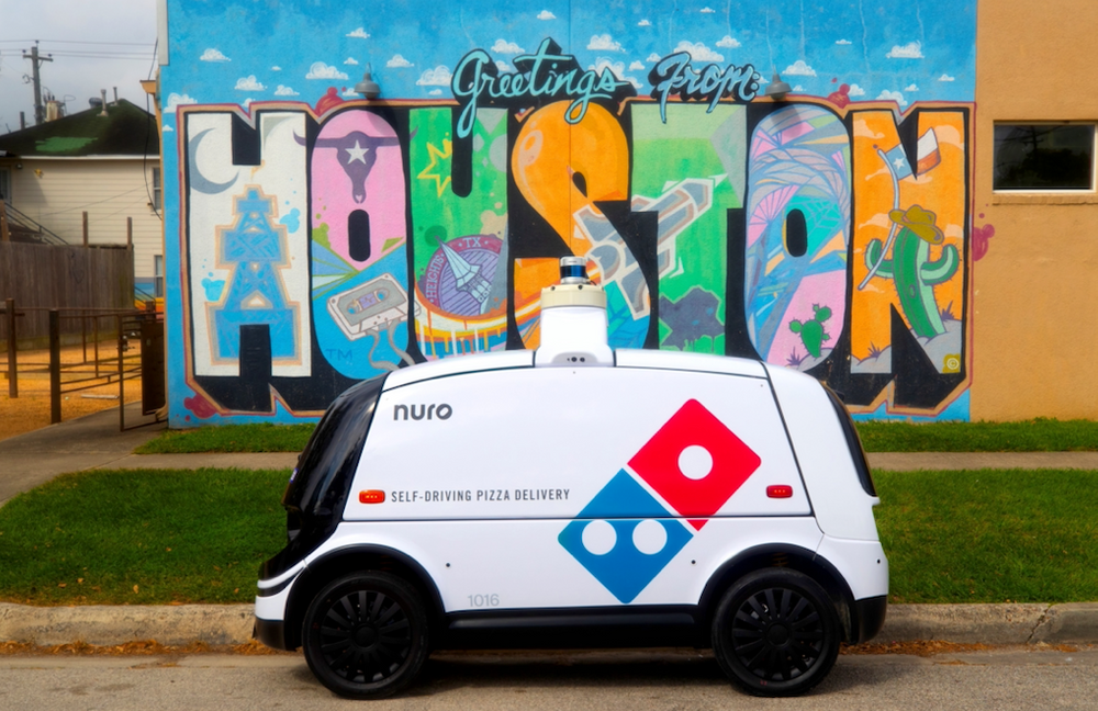 Nuro R2 vehicle with Domino's branding, in front of a 
