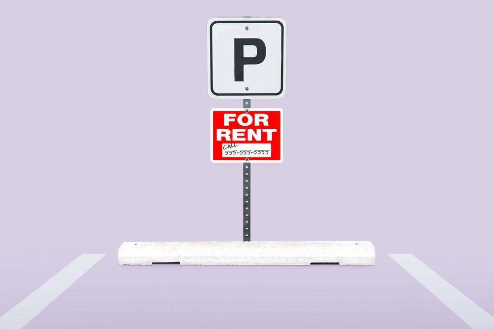 Parking space in a parking lot with a For Rent sign