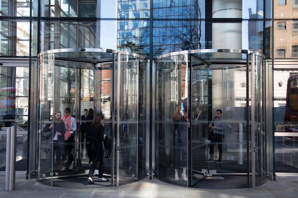 Modern glass revolving doors of offices at Heron Tower in the City of Lo...