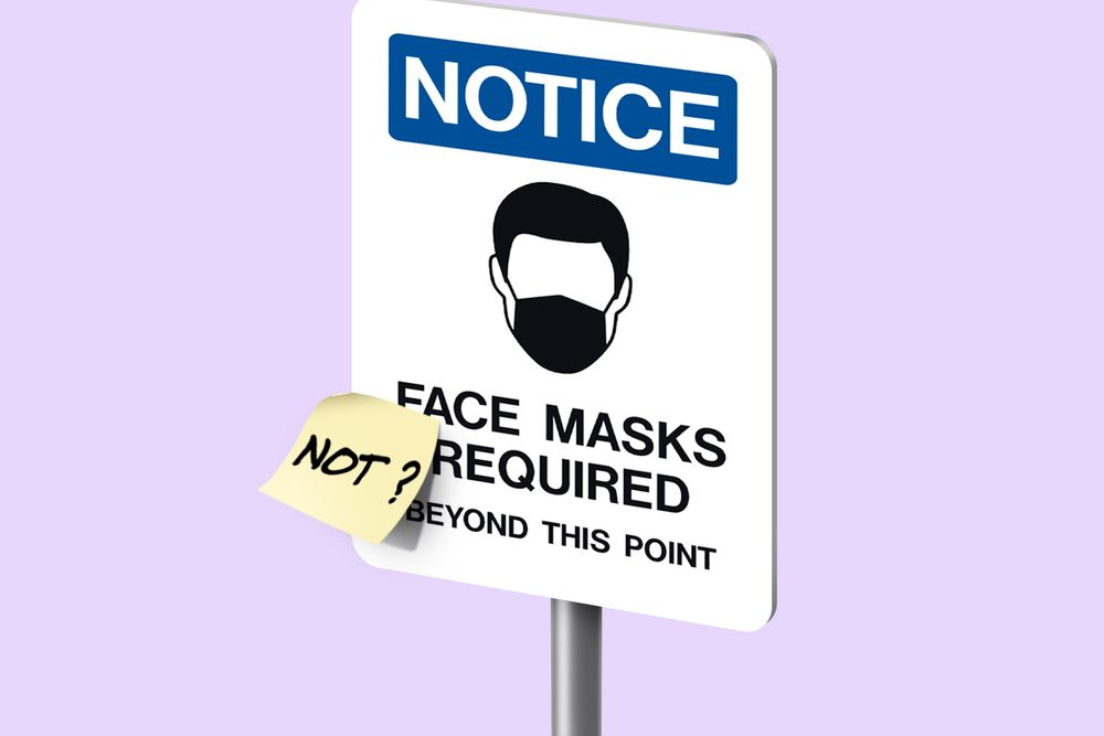 Notice sign with cartoon head wearing face mask. Reads Face Masks Required Beyond This Point, with sticky note that says "Not?" on it
