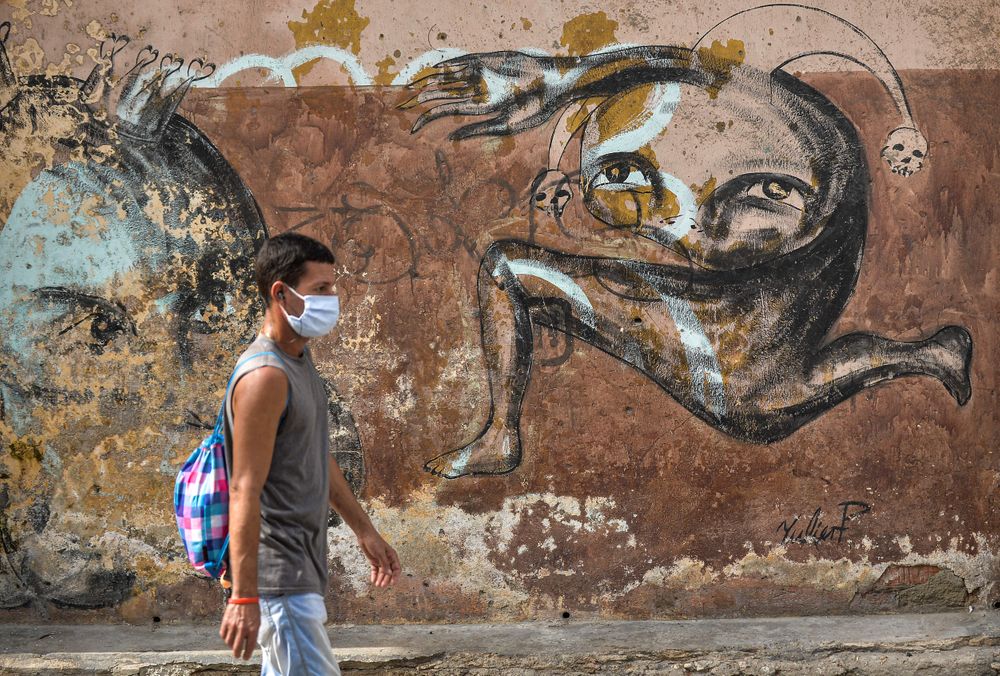 A man wearing a face mask walks along a street of Havana, on April 6, 20...