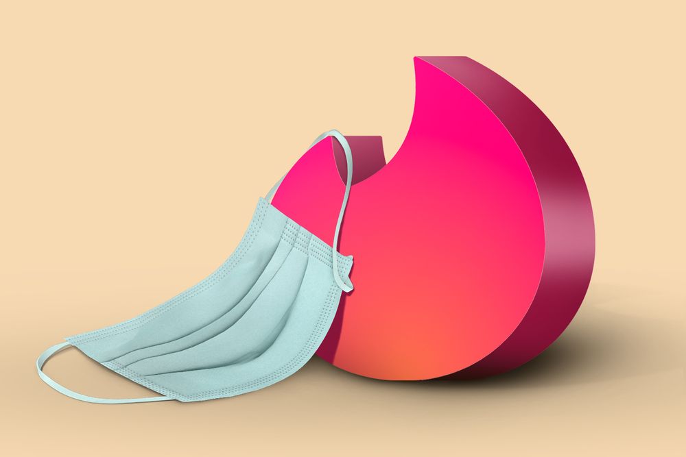 An illustration of Tinder's pink and orange fire logo in 3D. A mint-colored surgical mask is hanging off its side. 