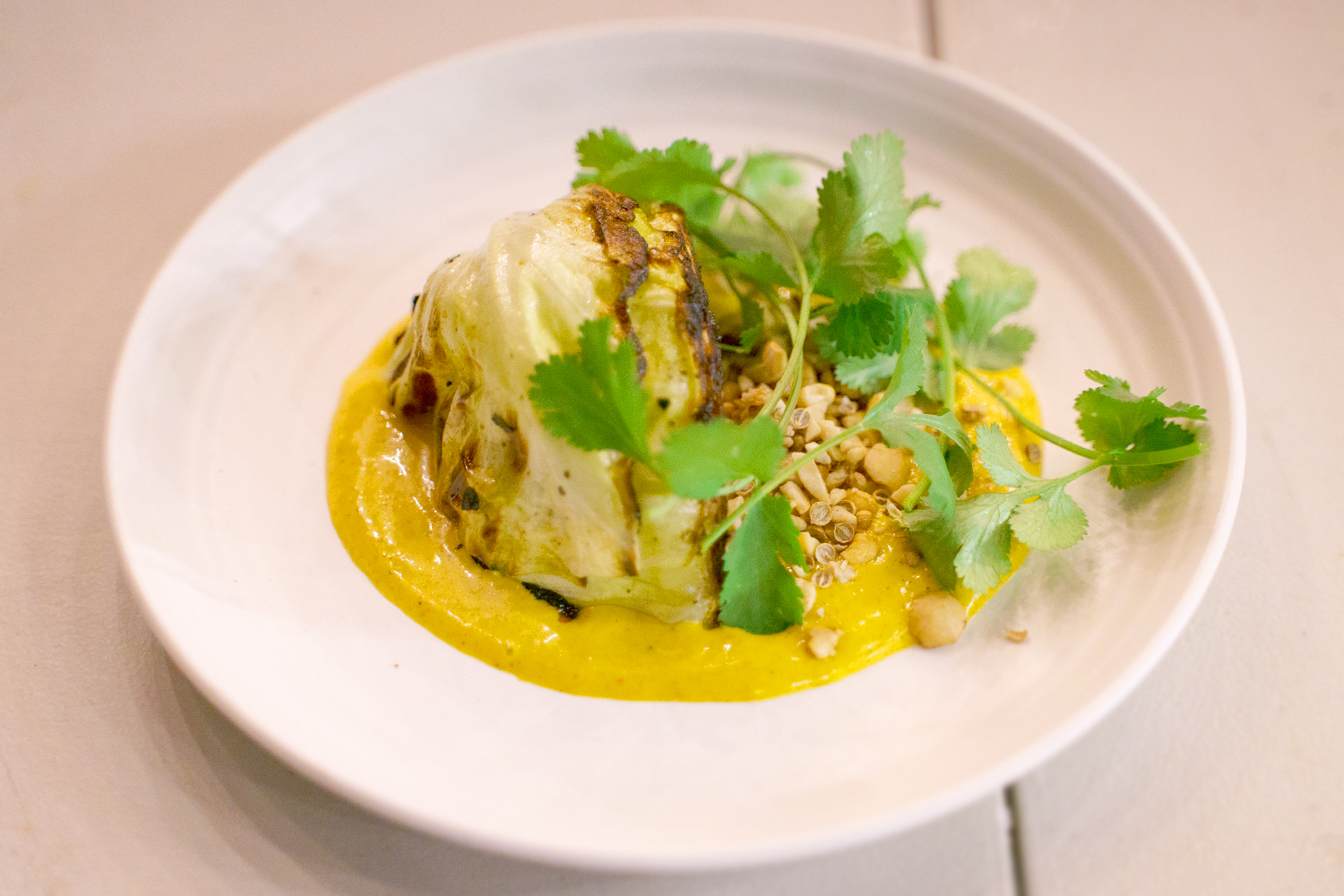 Grilled Cabbage with Vadouvan Vinaigrette and Coriander Peanuts
