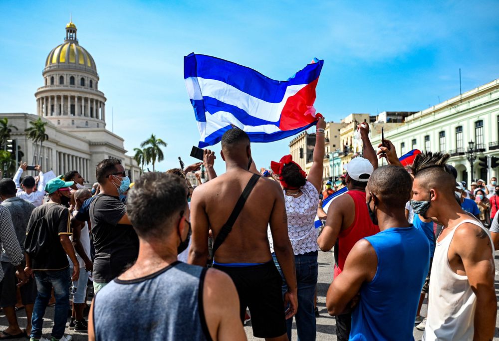 TOPSHOT - Cubans are seen outside Havana's Capitol during a demonstratio...