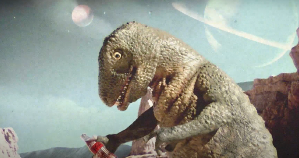 dinosaur holding a Coke