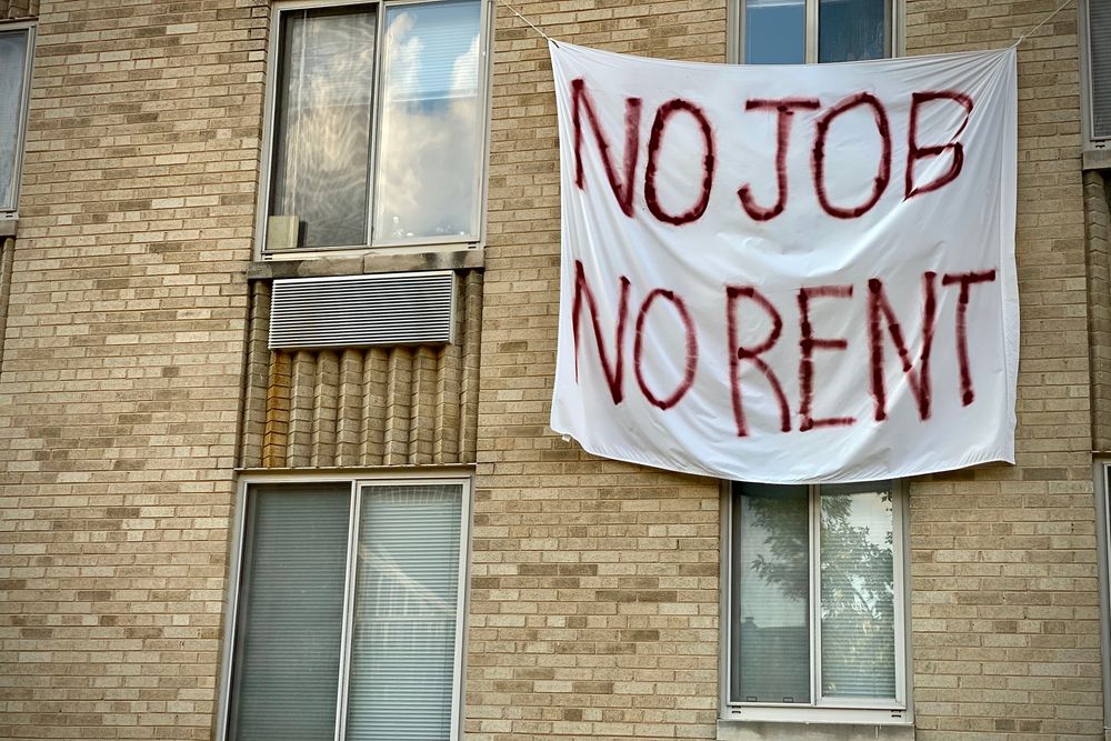 A banner against renters eviction reading no job, no rent is displayed o...