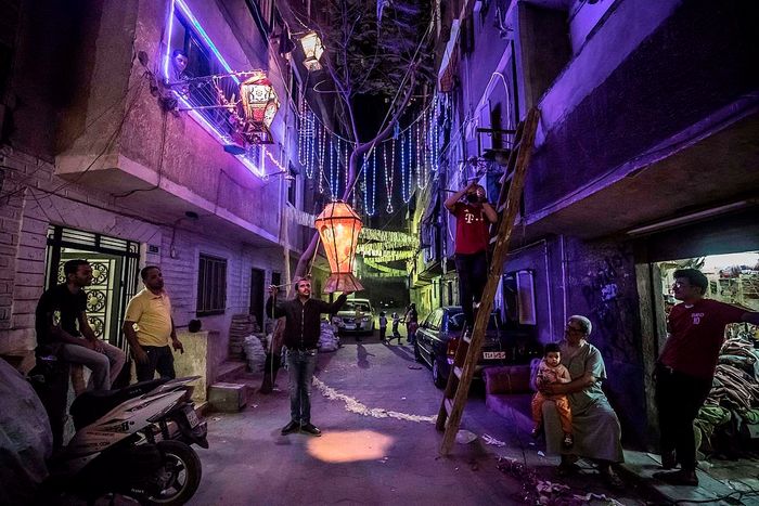 Egyptian youths decorating their Cairo street for Ramadan