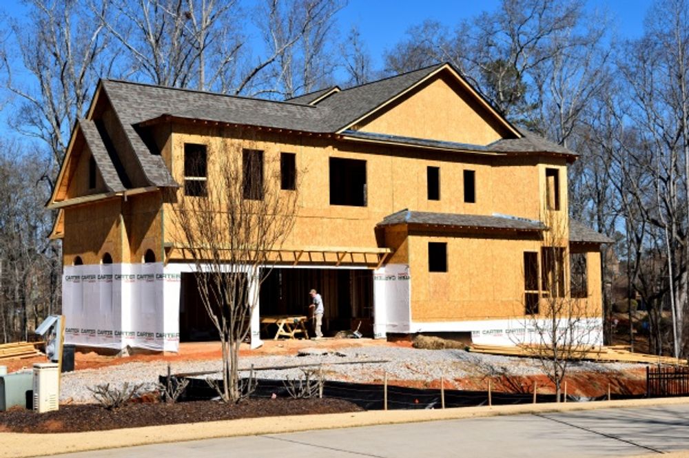 Photo of a new home under construction in a residential area.