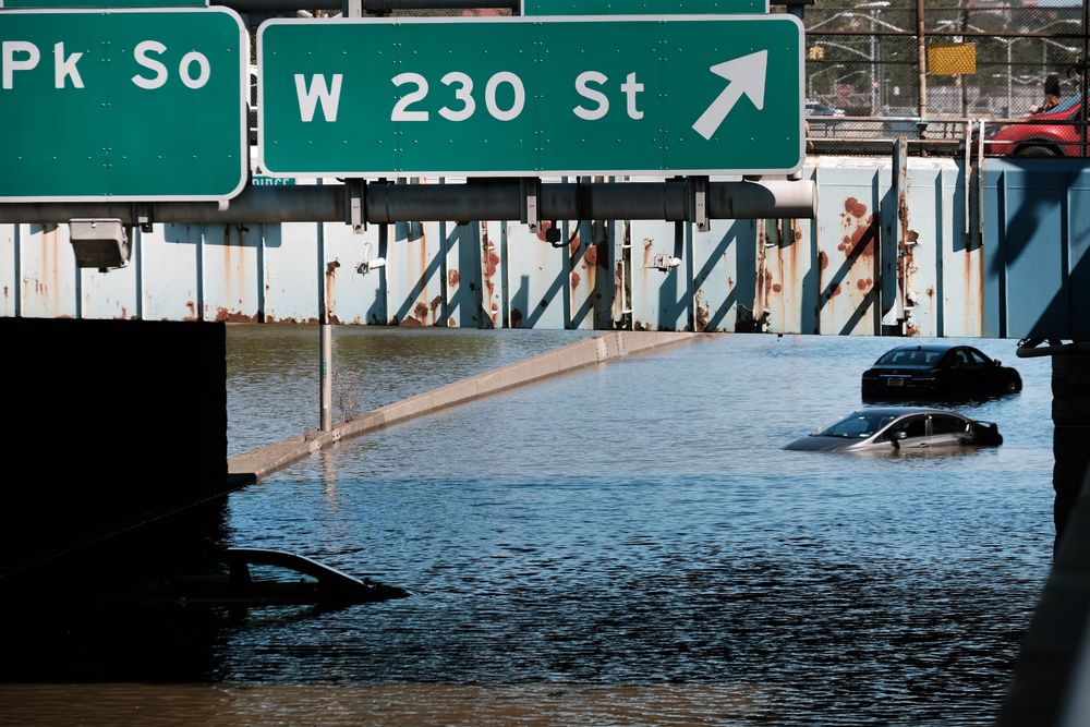 NEW YORK, NY - SEPTEMBER 02: Cars sit abandoned on the flooded Major Dee...