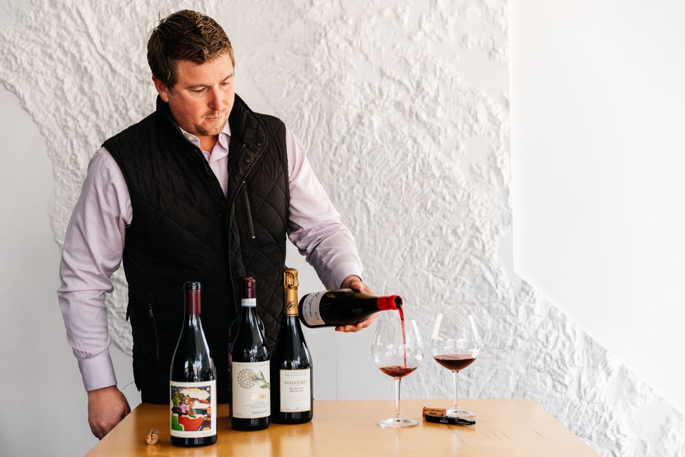 Ian Cauble, Master Sommelier pours wine into a glass