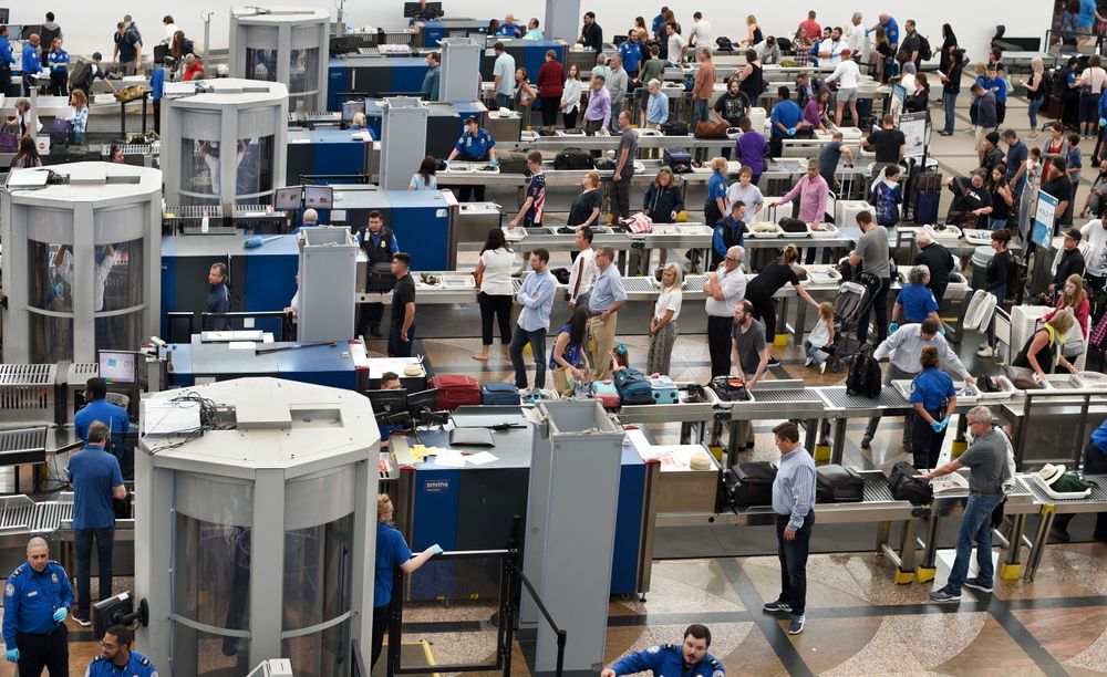 DENVER, COLORADO - JUNE 20, 2019: Airplane passengers line up for TSA se...