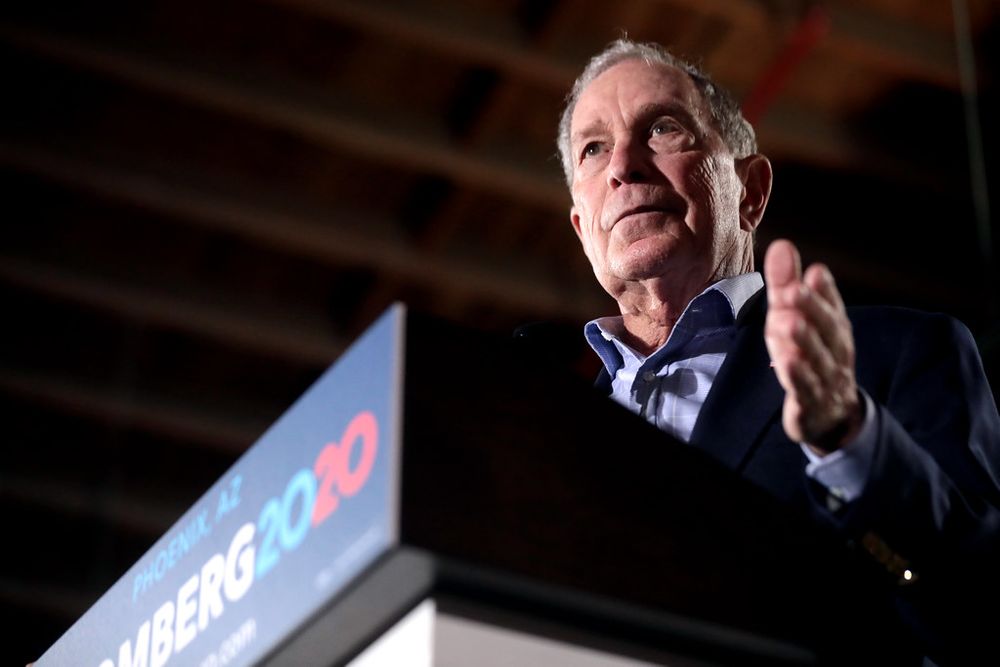 Mike Bloomberg speaks at a podium in presidential campaign