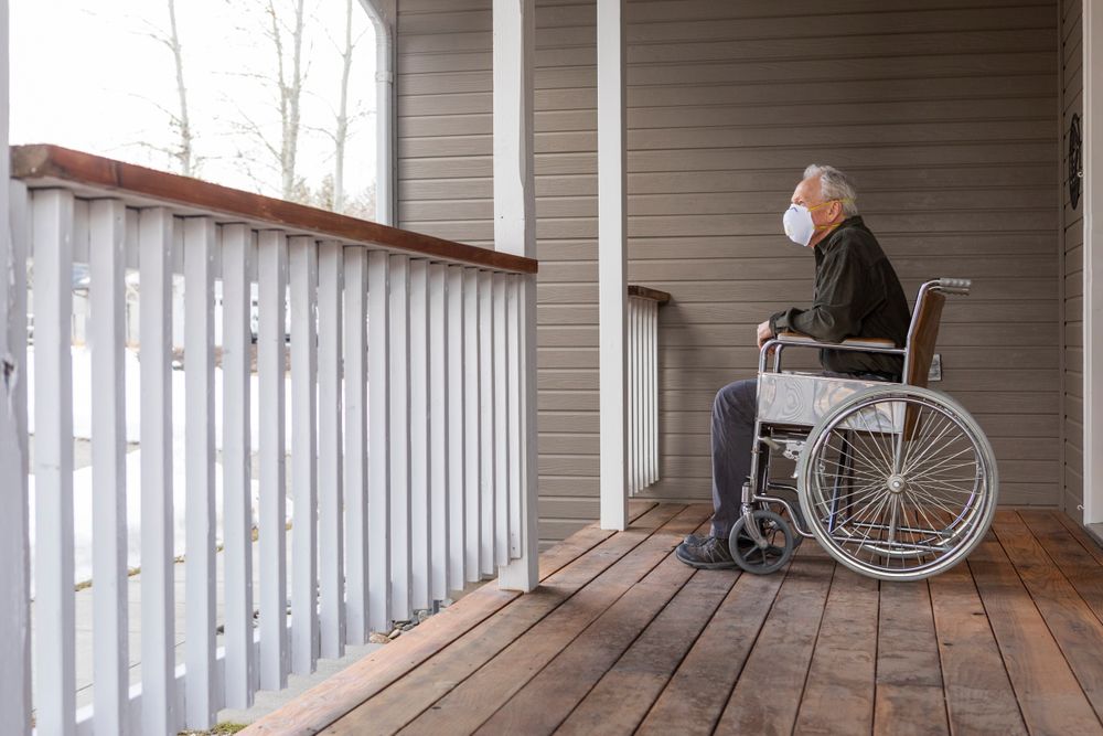 Senior in wheelchair on his porch