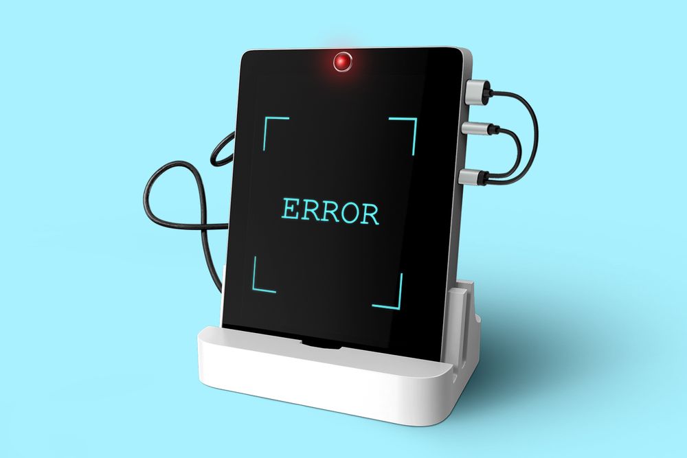 Tablet plugged into dock displaying error message