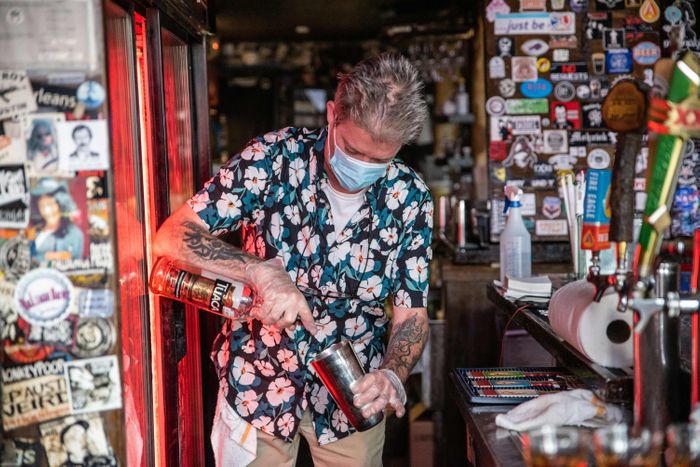 Florida masked bartender pouring a drink