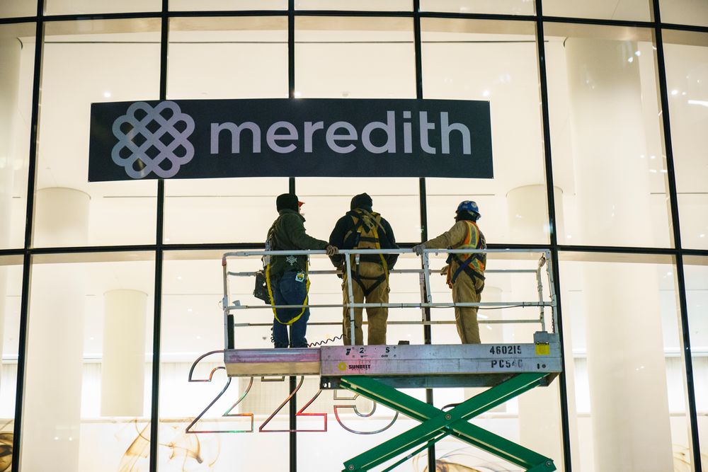 NEW YORK, NY - JANUARY 31: Workers cover up Time Inc. signage with Mered...