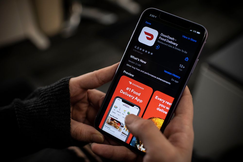 An AFP journalist checks the DoorDash food delivery application on her s...