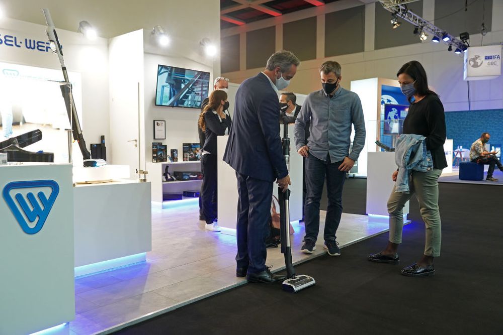 People trying a Wessel Werk vacuum cleaner at the 2020 IFA trade fair 