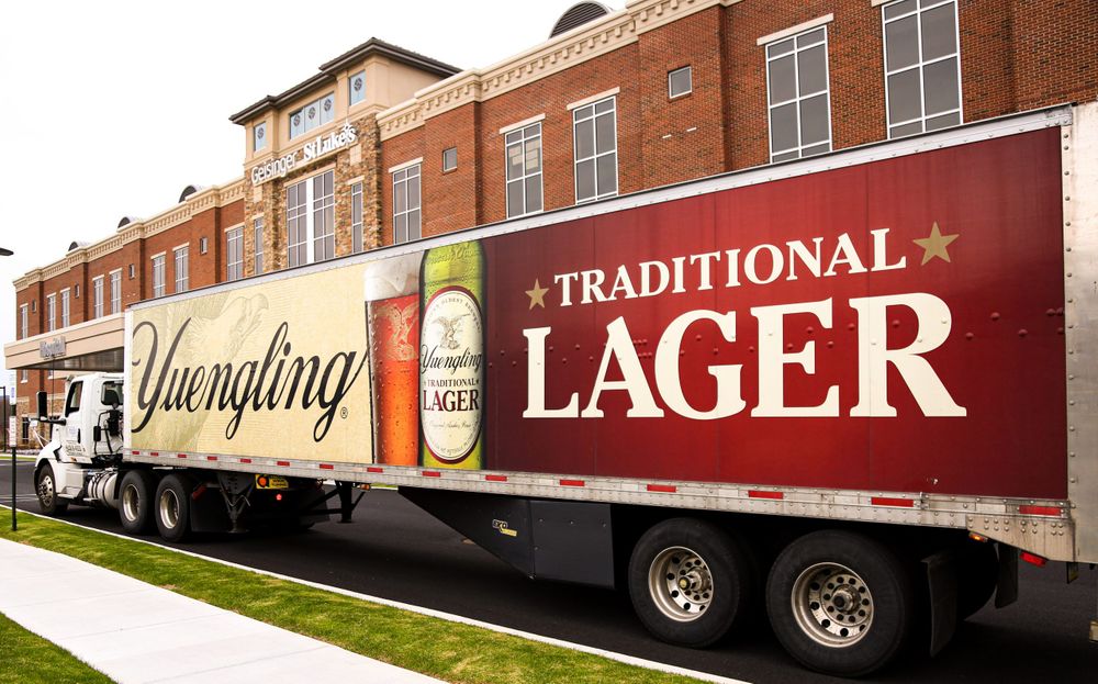 A Yuengling truck outside a building 