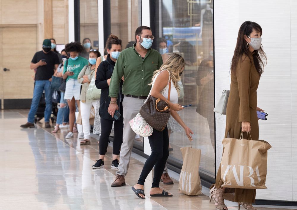 COSTA MESA, CA - AUGUST 31: Shoppers wait in line at Zara before the sto...