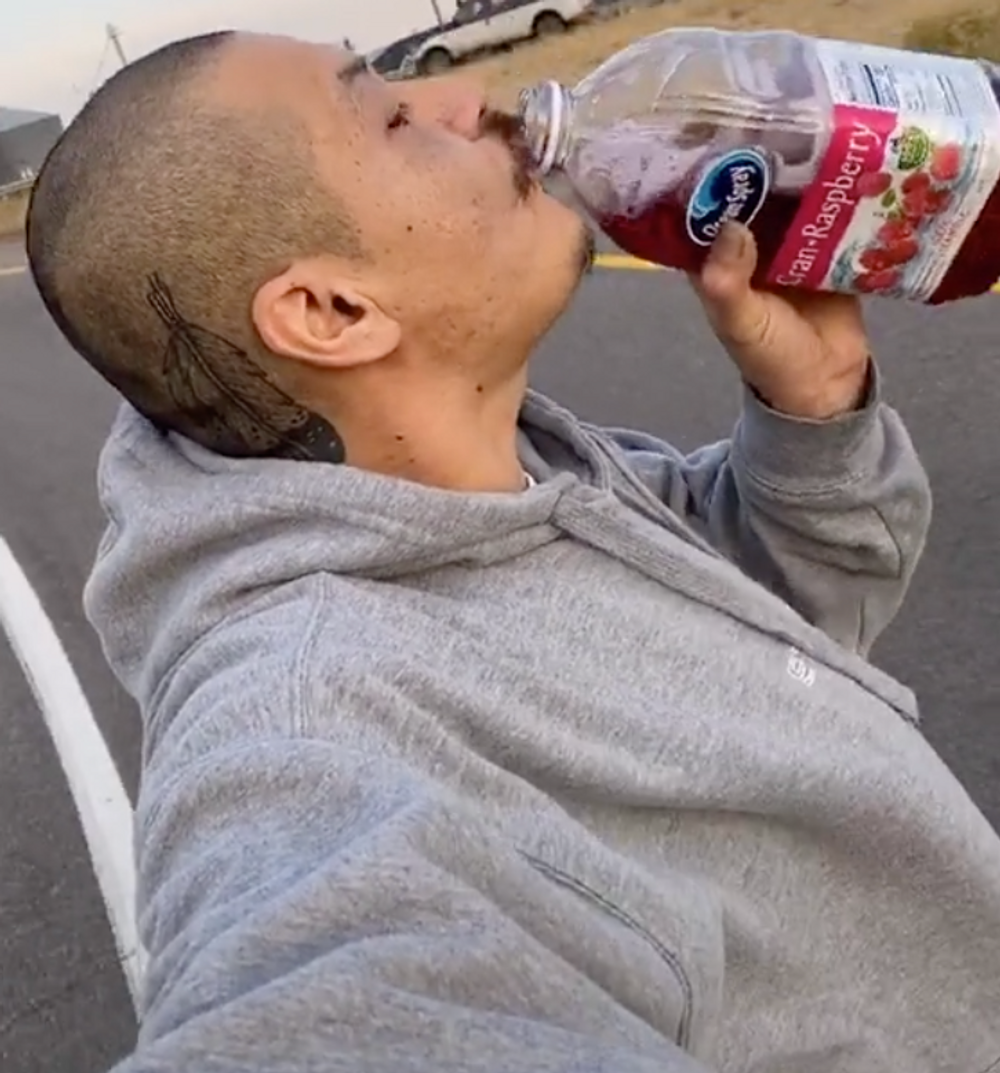 Man on skateboard drinking Ocean Spray 