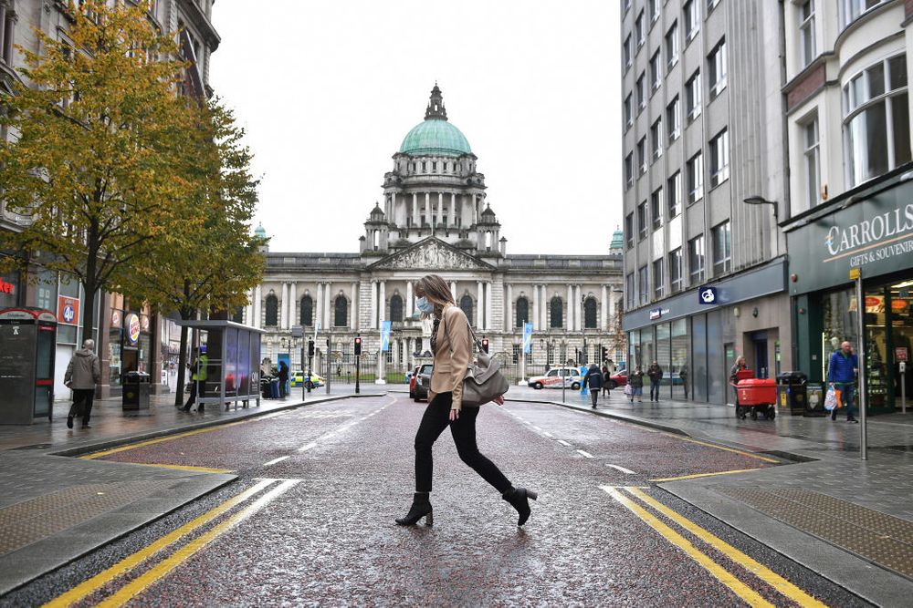 A woman crosses the street in Belfast, Northern Ireland 