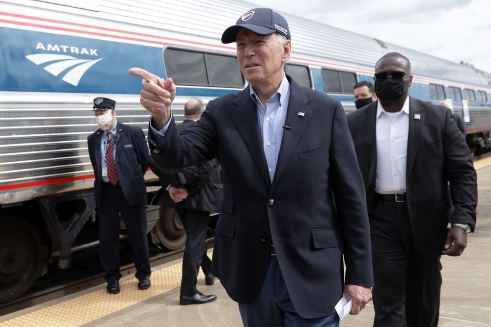 Presidential candidate Joe Biden next to an Amtrak train 