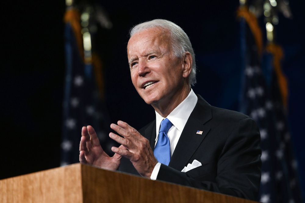 A photograph of Joe Biden speaking at a podium