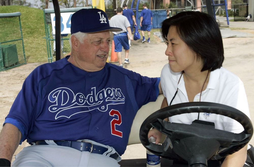 Kim Ng and Tommy Lasorda in a golf cart