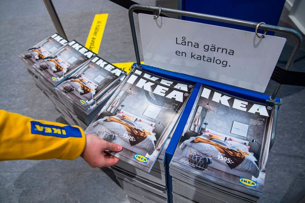 Hand reaching for Ikea catalogs 